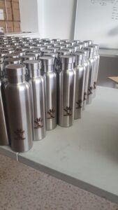 Drinking Bottles with JoyRon logo lined up ready to be name engraved